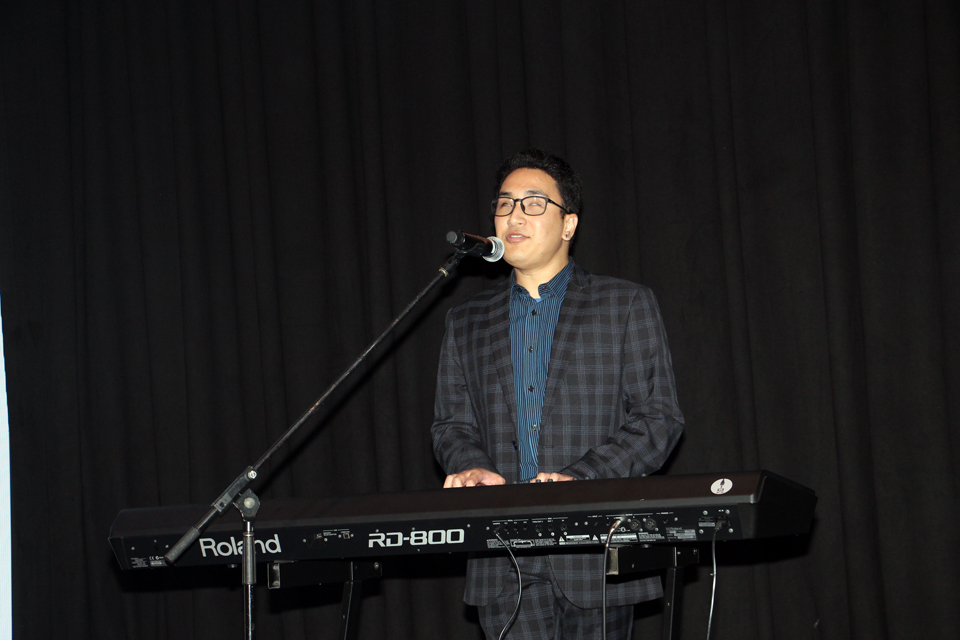 Claro performing on the piano for Vision Australia Black and White Committee